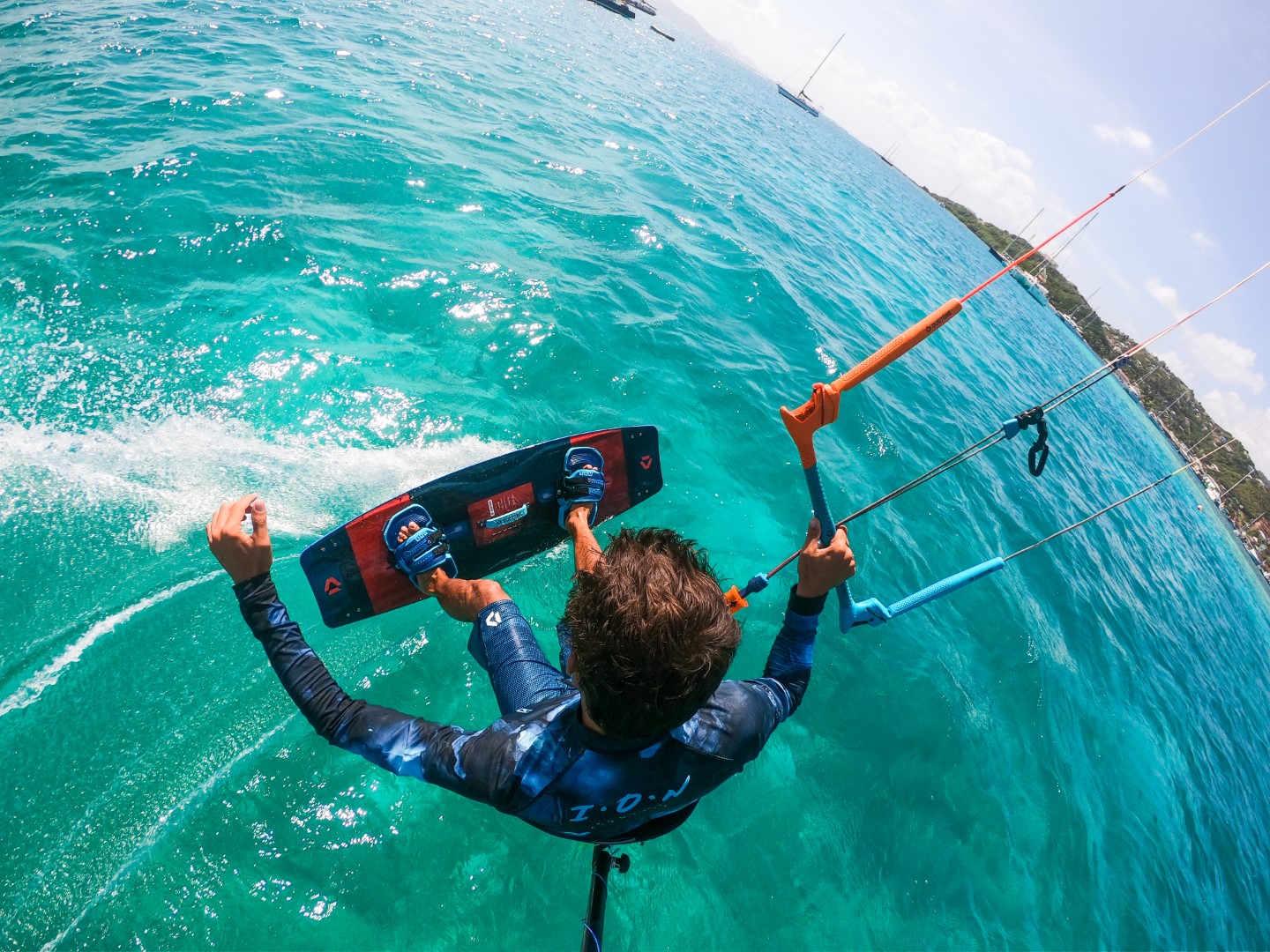 Jeremie Tronet kiteboarding above turquoise water in the Grenadines