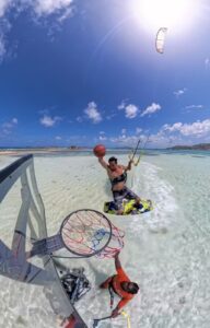 Viral basketball kitesurfing concept in turquoise water