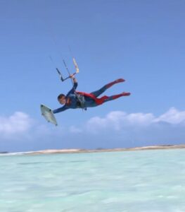 Jeremie kitesurfing in a Superman costume